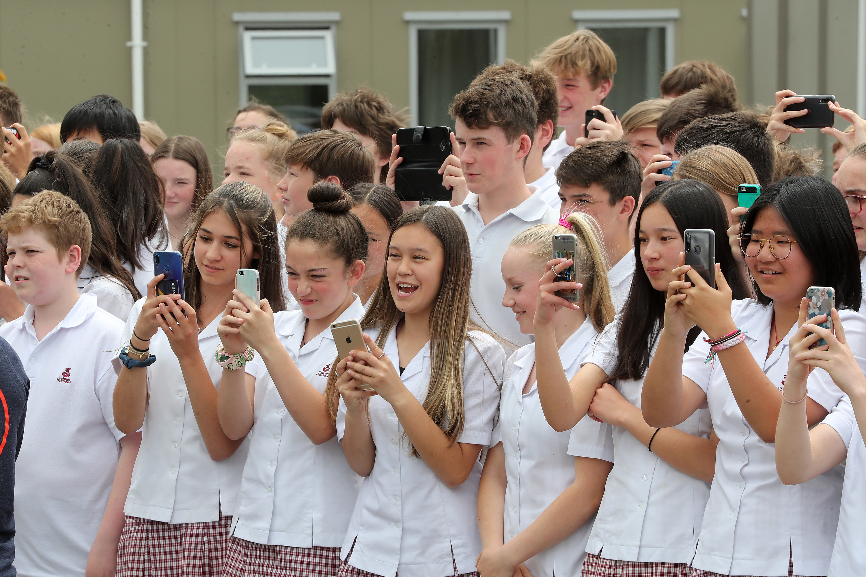 New Zealand students lined up outside of their school for a photo opportunity