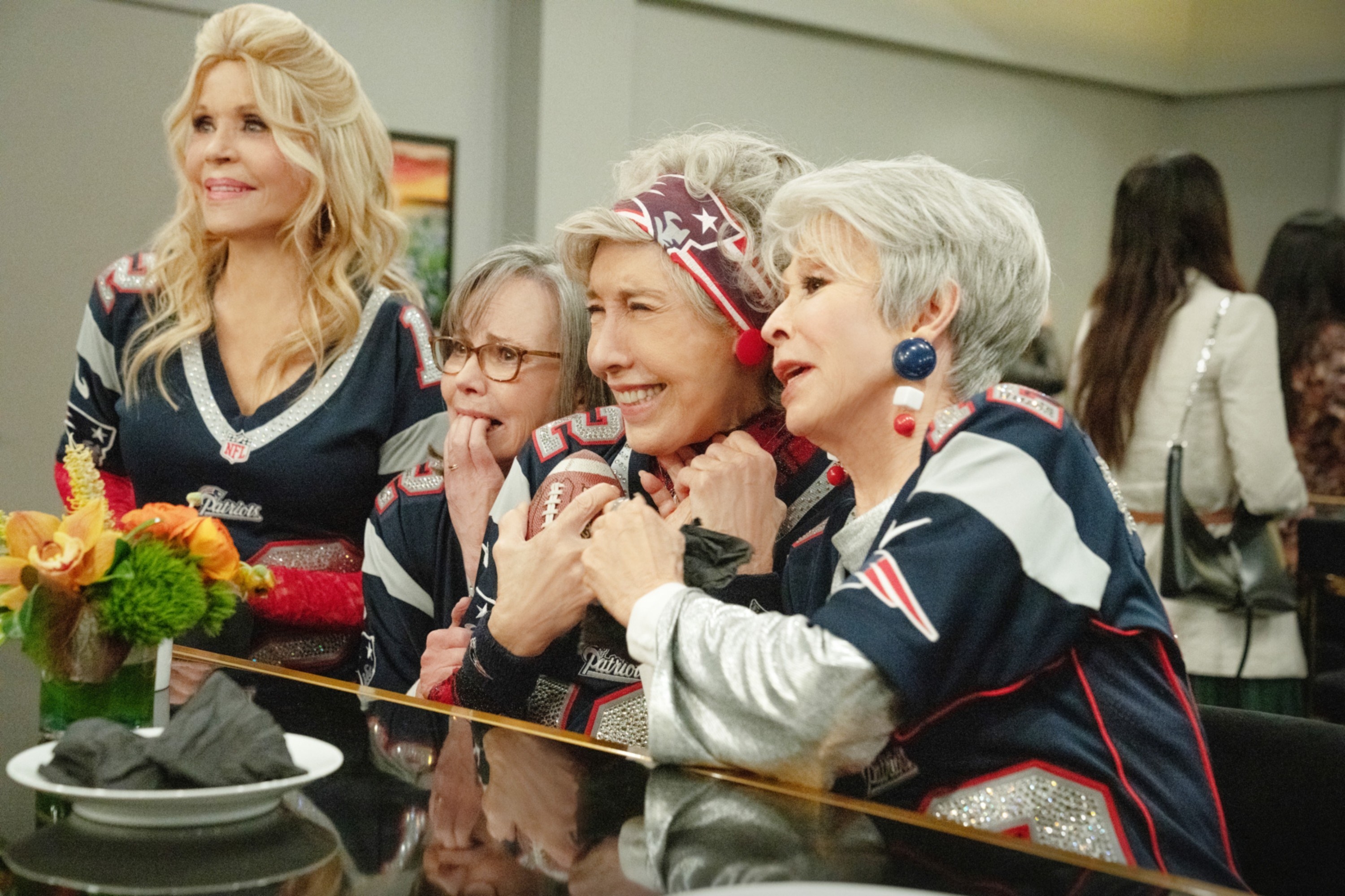 The girls nervously watching the game from a sky box