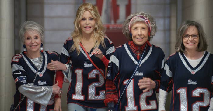 Rita Moreno, Jane Fonda, Lily Tomlin, Sally Field wearing bedazzled football jerseys, arm in arm