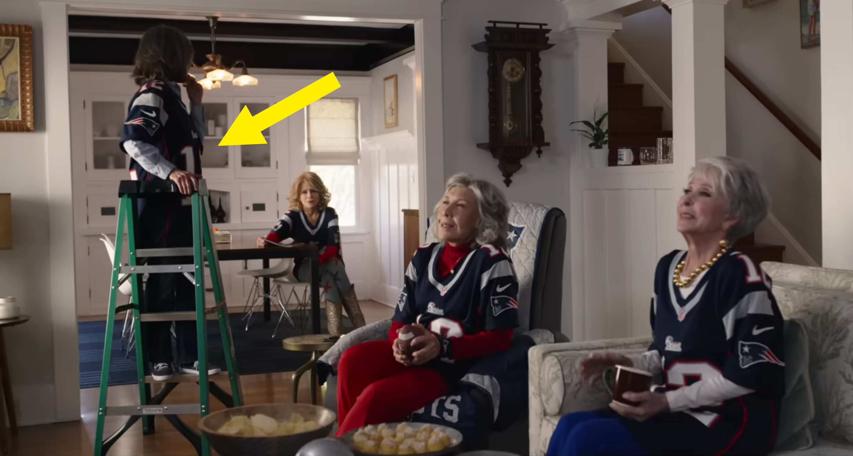 The girls watching the game with Sally standing on a ladder