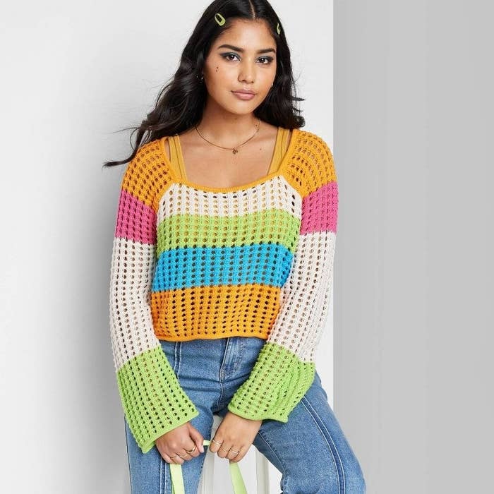 Model wearing the striped pullover sweater