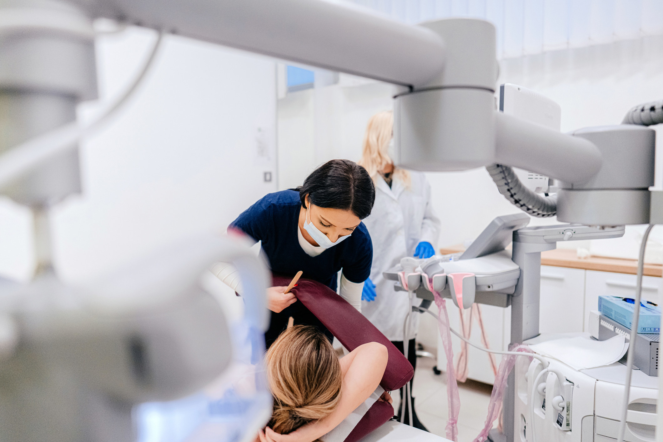 Nurse prepares patient for breast exam