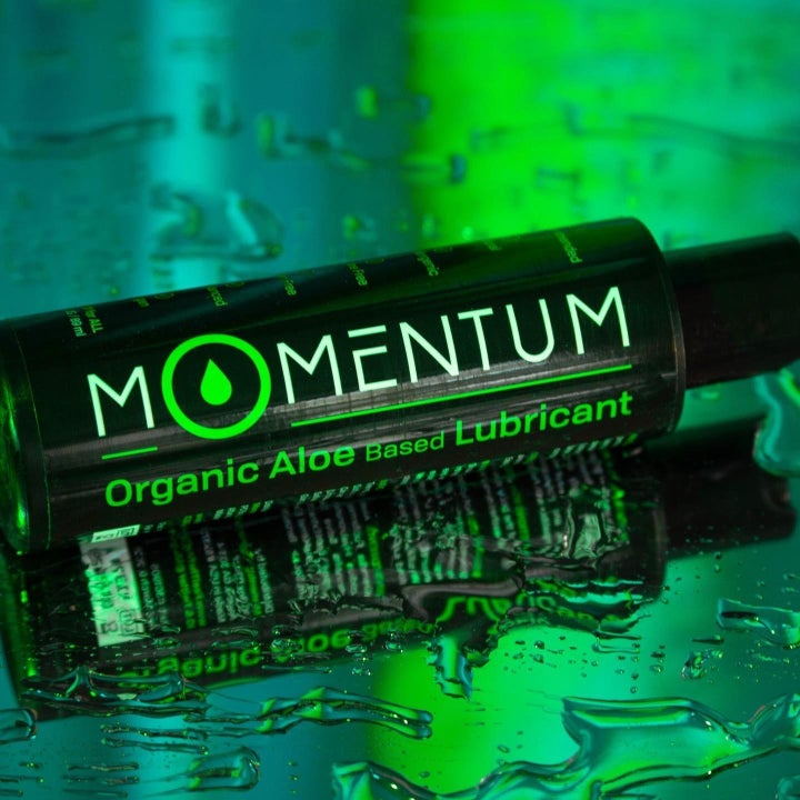 Black and green bottle of aloe-based lubricant