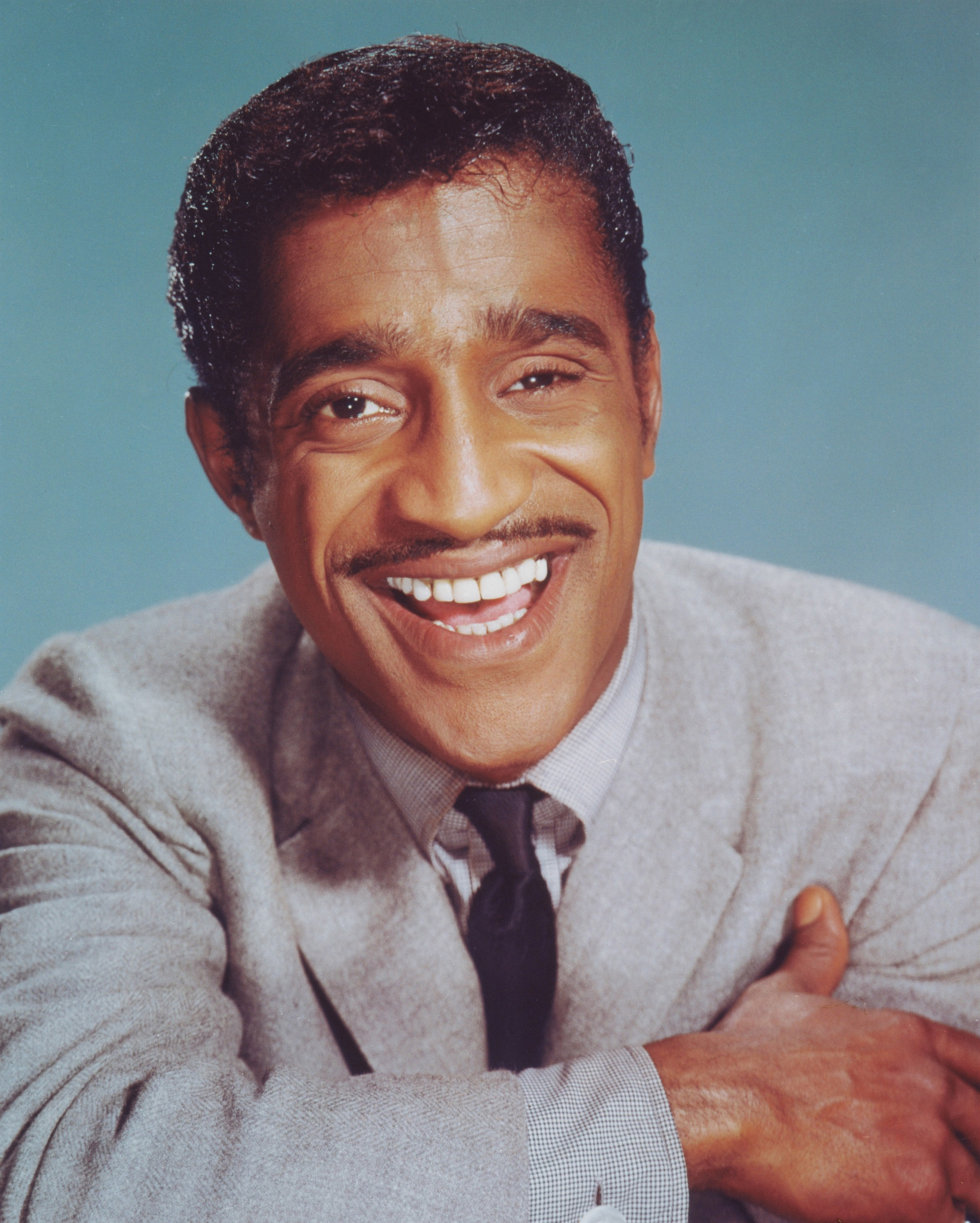 A portrait of Sammy Davis Jr smiling