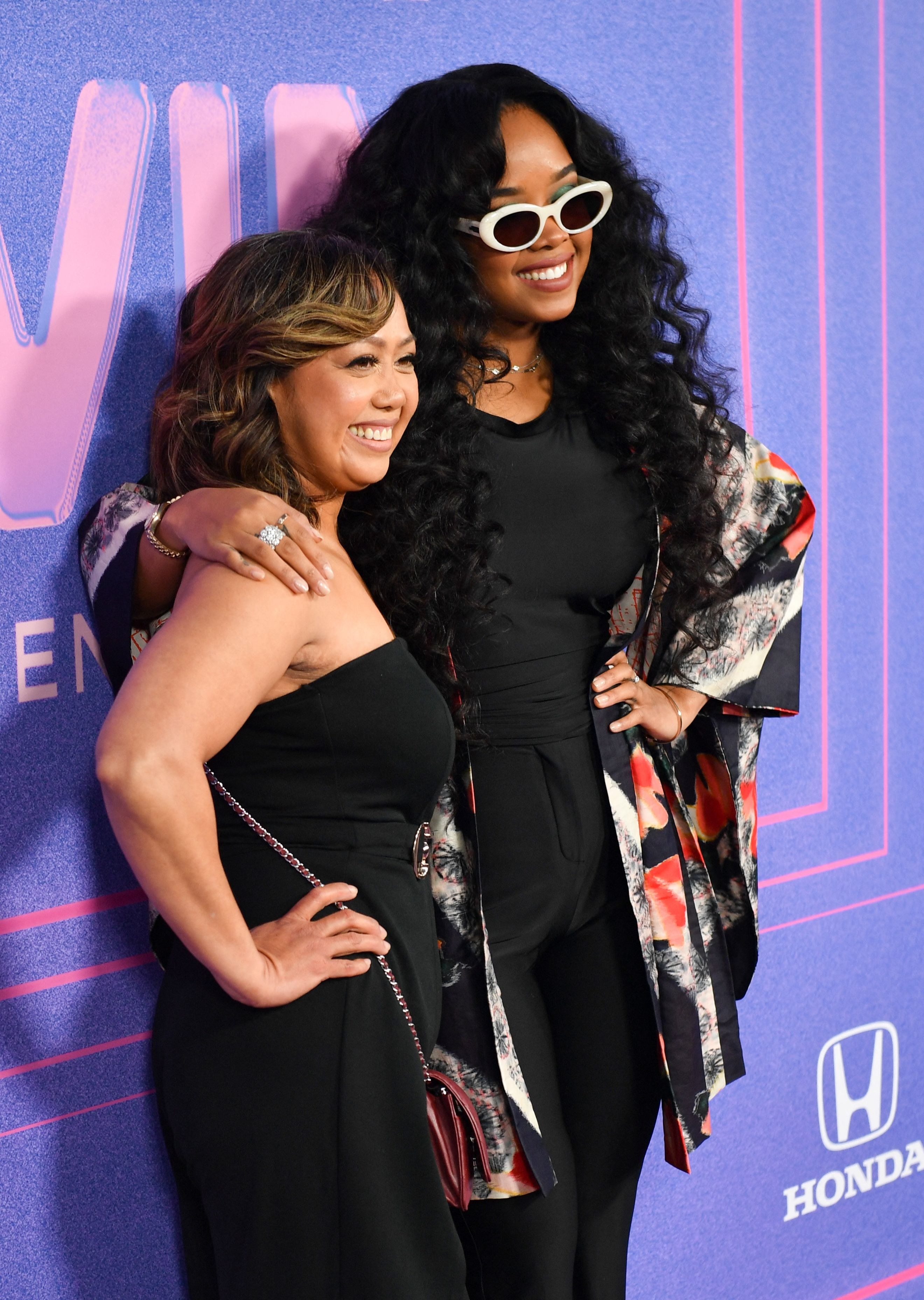 US singer-songwriter H.E.R. and her mother Agnes Wilson smile for photographers at the 2022 Billboard Women in Music awards