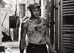 Marlon Brando walks through an alleyway in A Street Car Named Desire