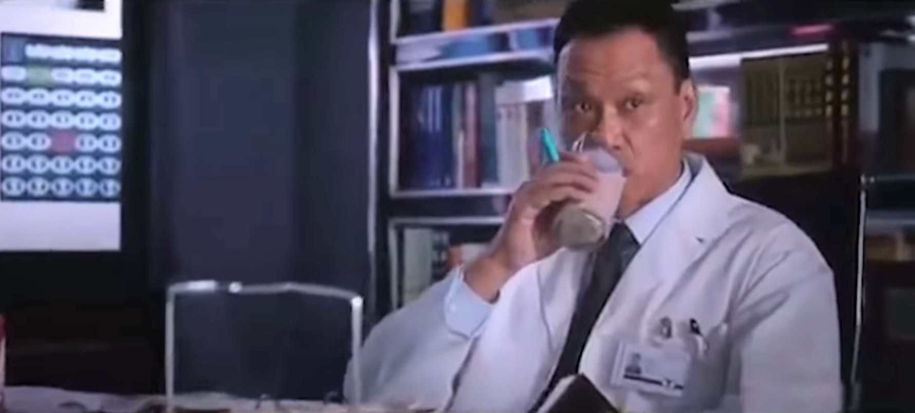 The character Dr Wu played by Wang Xueqi takes a sip from a drink in Iron Man 3