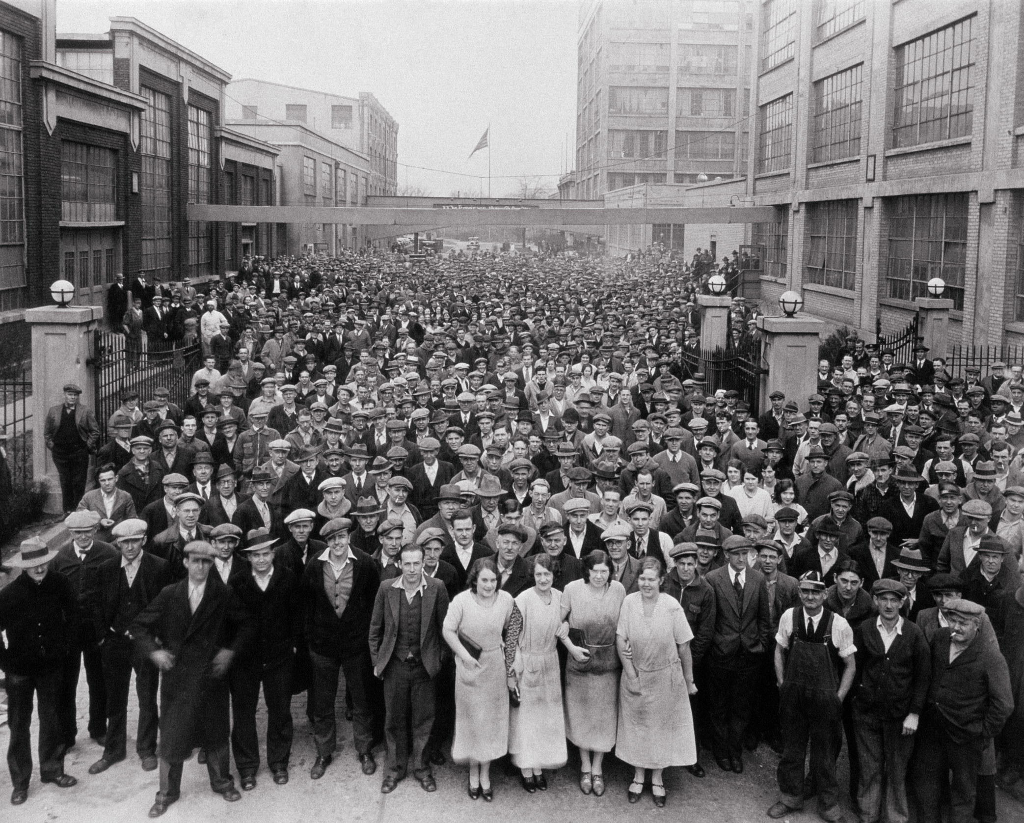 A crowd of men and women pose for a picture outdoors