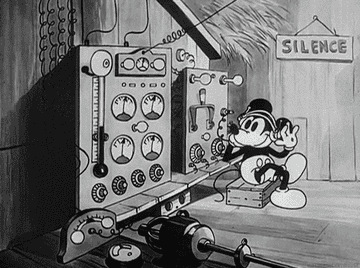 An old cartoon of Mickey Mouse listening to radio