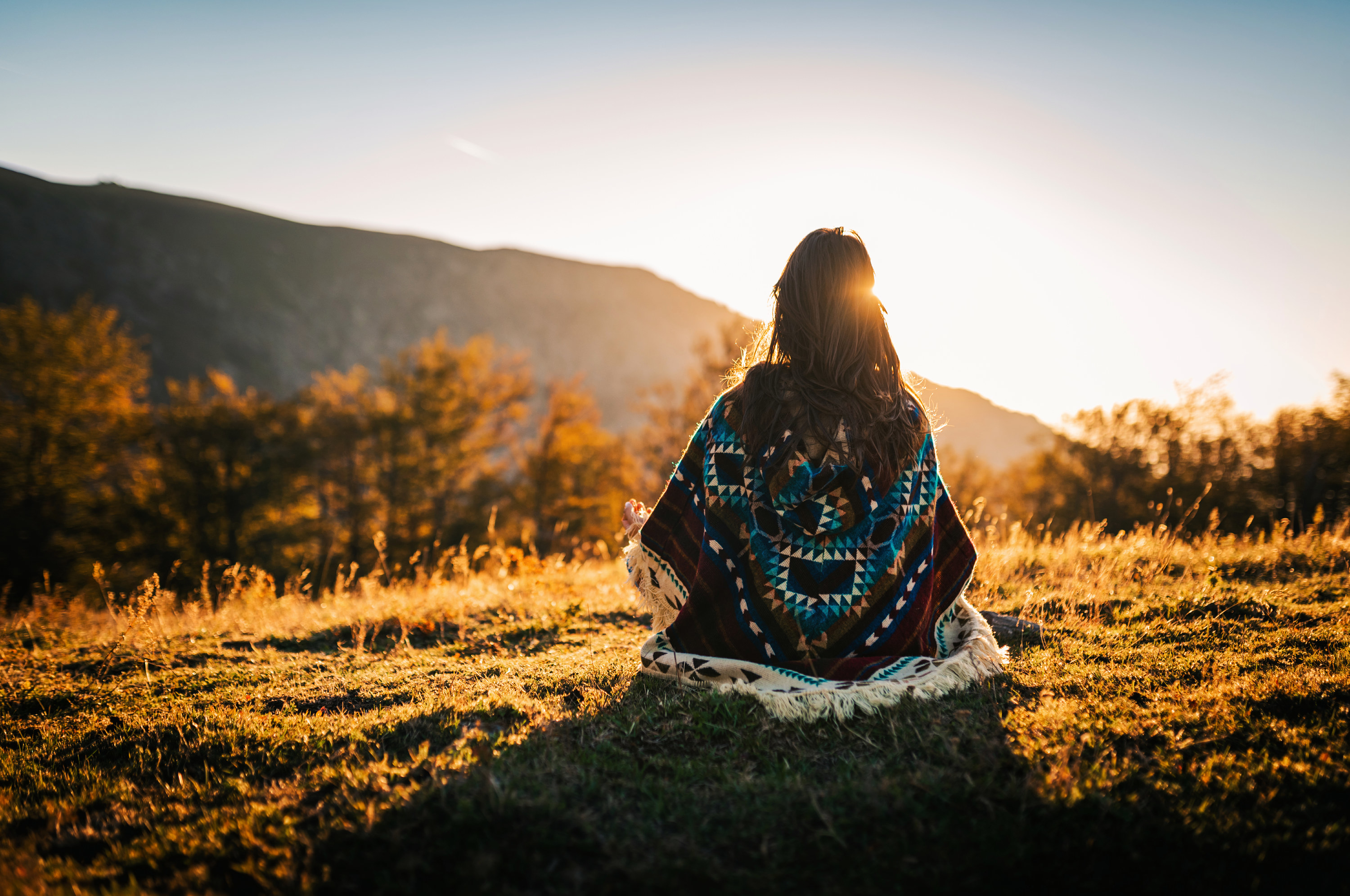Woman sitting in a woven Native American blanket