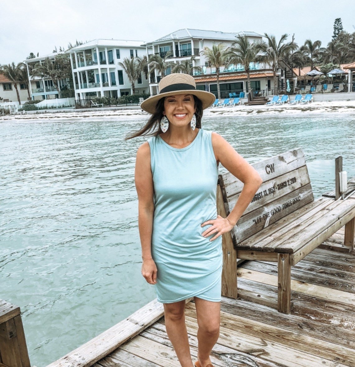 Reviewer posing in the light blue dress on pier