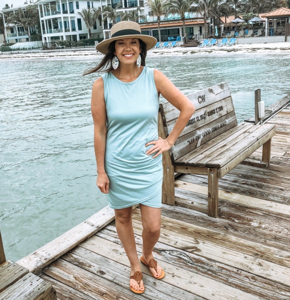 Reviewer posing in the light blue dress on pier