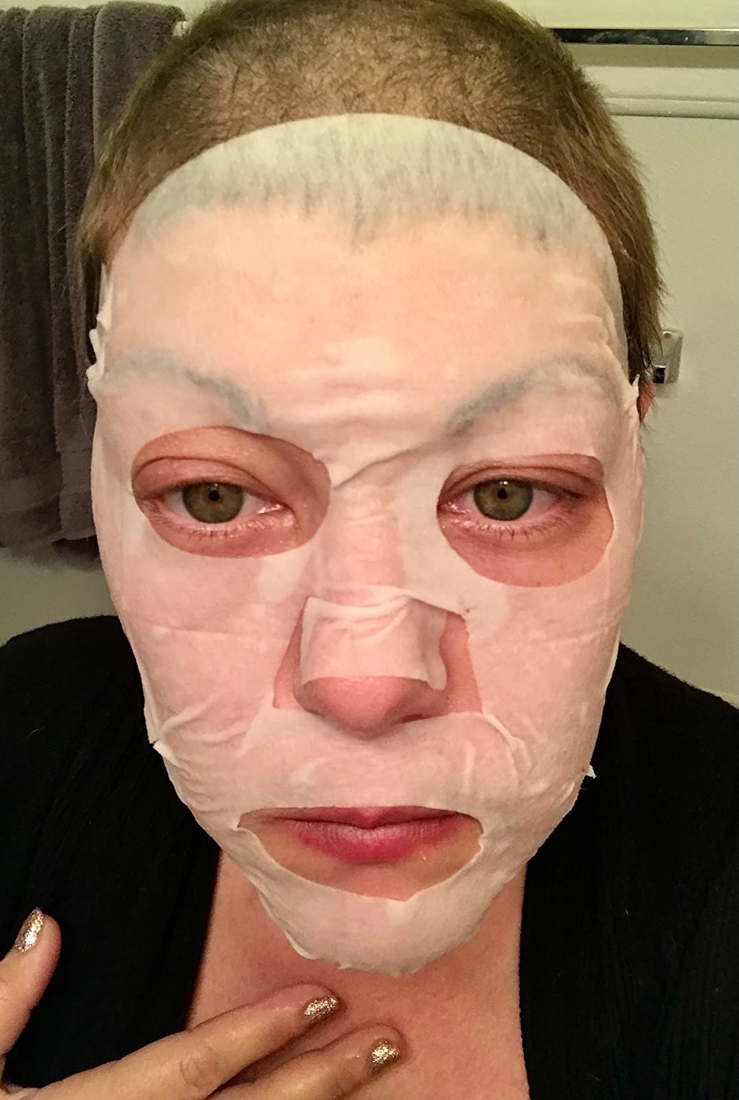 person with sheet mask applied to their face