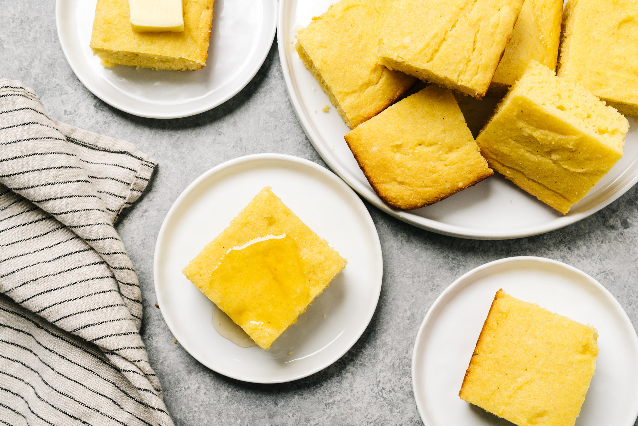 Golden cornbread squares topped with butter or honey.