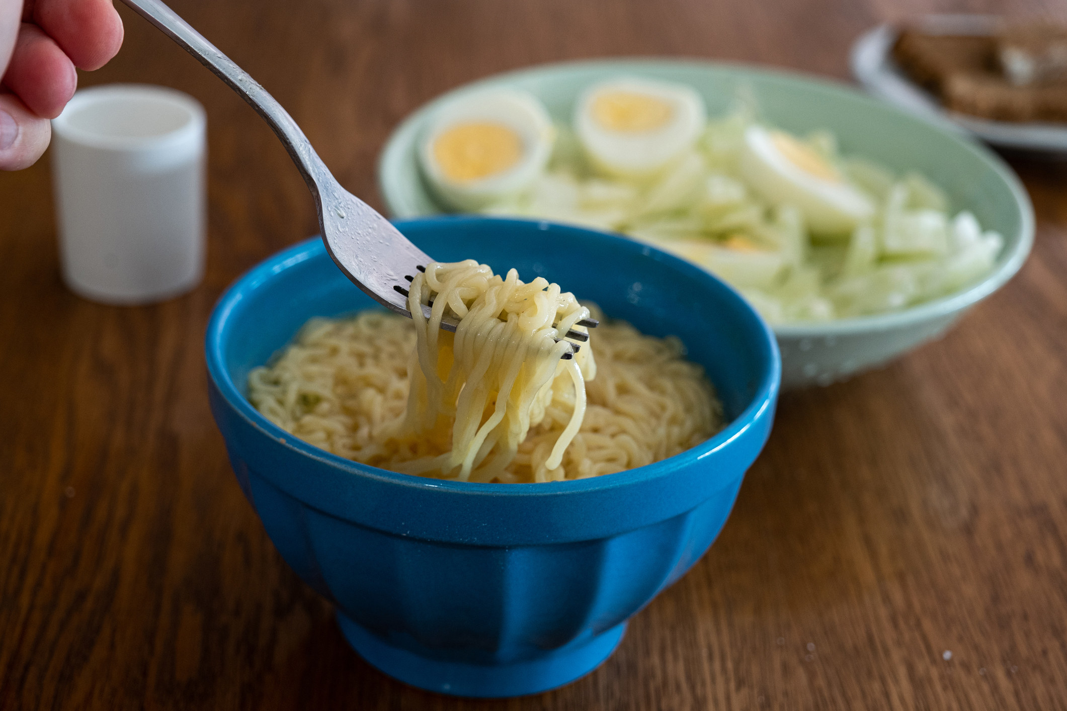 Eating a bowl of ramen.