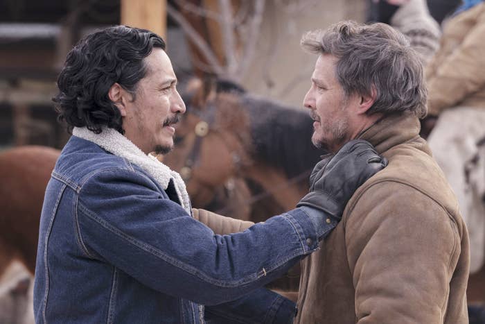 Gabriel Luna as Tommy holding onto the shoulders of Joel, played by Pedro Pascal