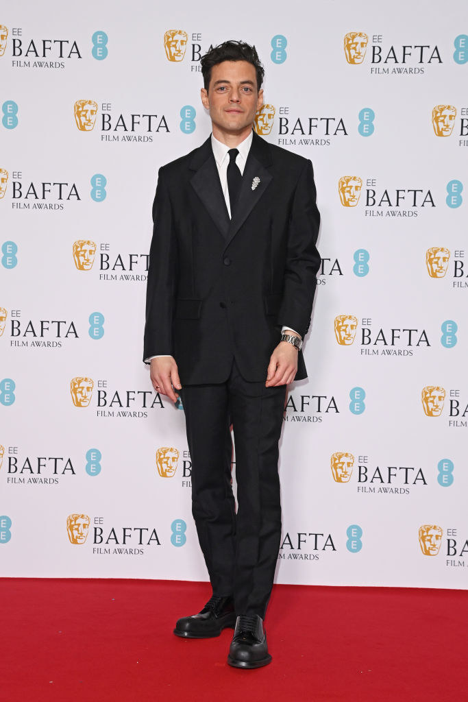 Rami Malek poses in the Winners Room at the EE BAFTA Film Awards 2023 at The Royal Festival Hall in a suit