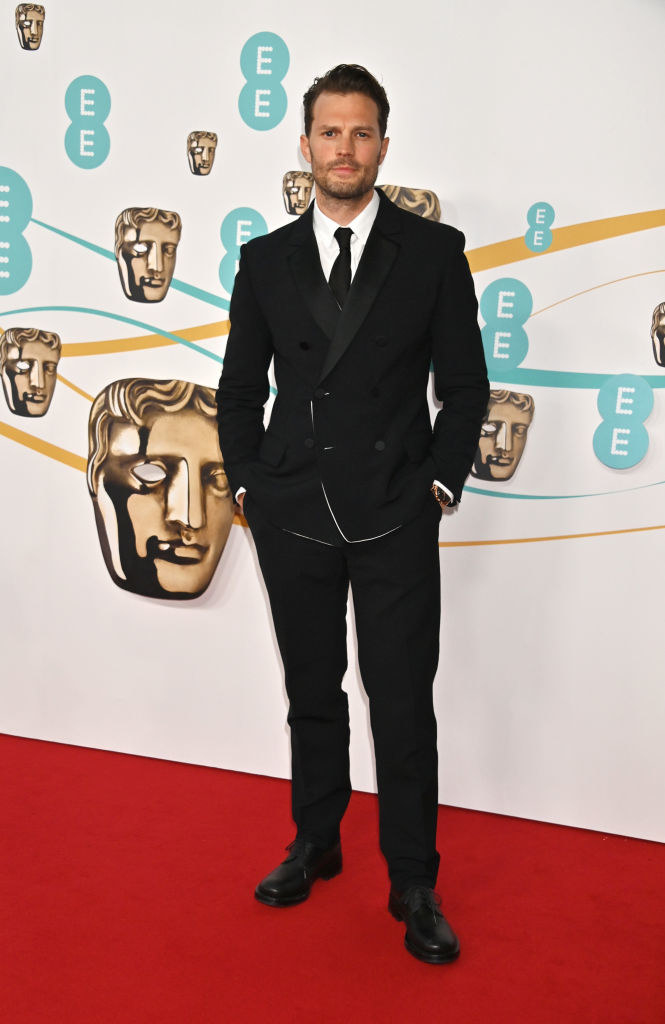 Jamie Dornan arrives at the EE BAFTA Film Awards 2023 at The Royal Festival Hall in a suit