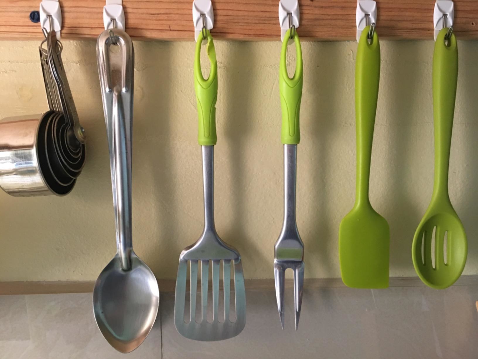 reviewer photo of Command hooks being used for various kitchen utensils