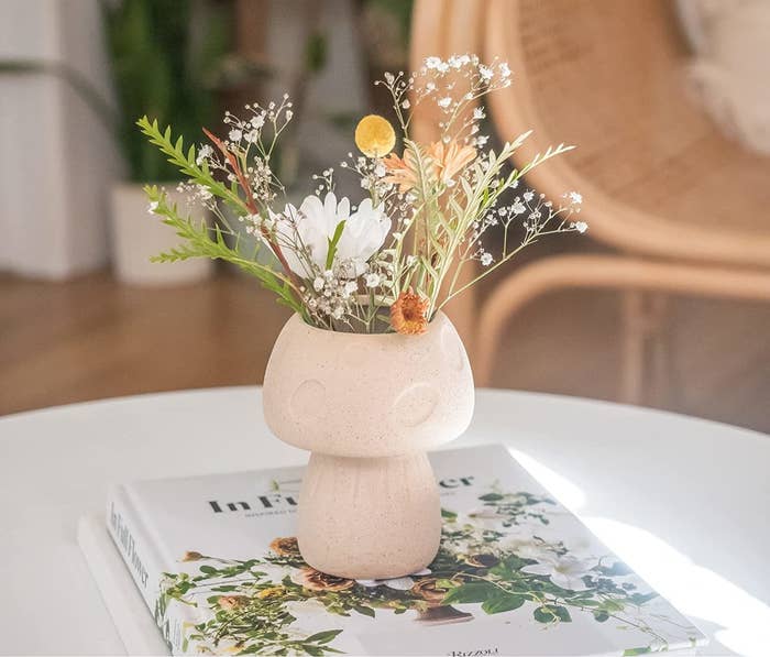 a mushroom shaped vase on a coffee table