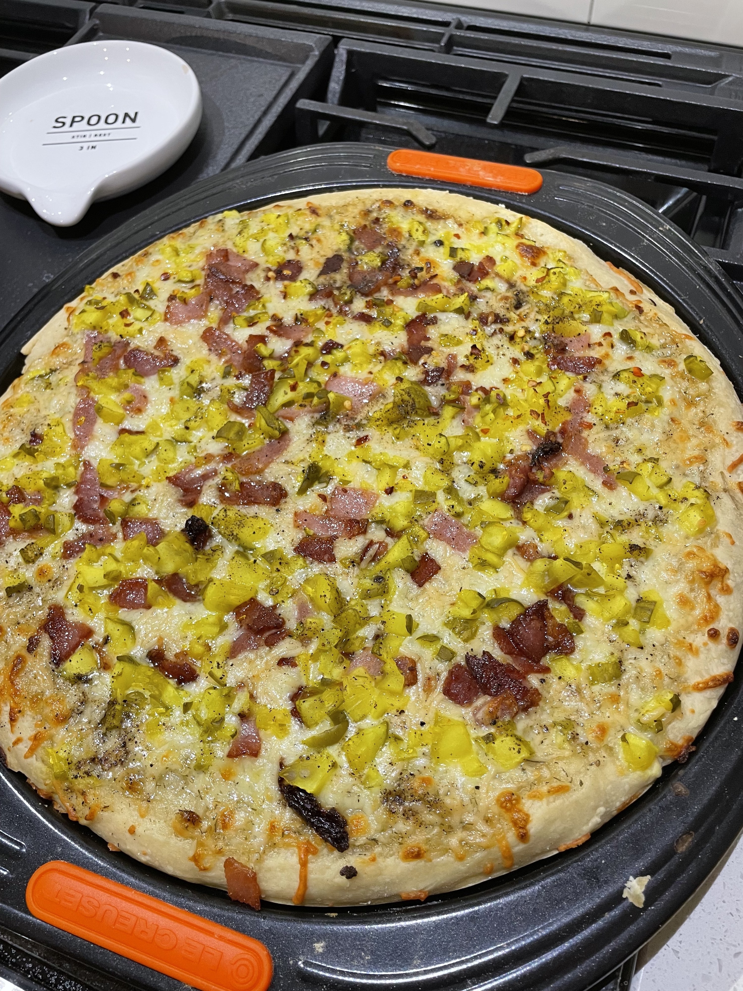 pickle pizza cooked on a pizza pan