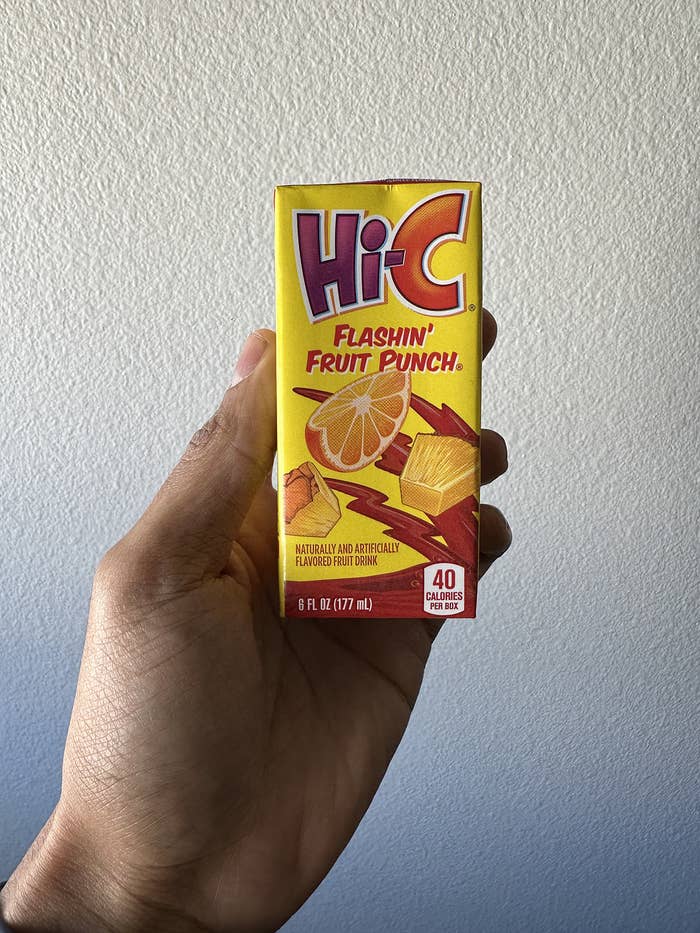 A hand holding a small box of Hi-C