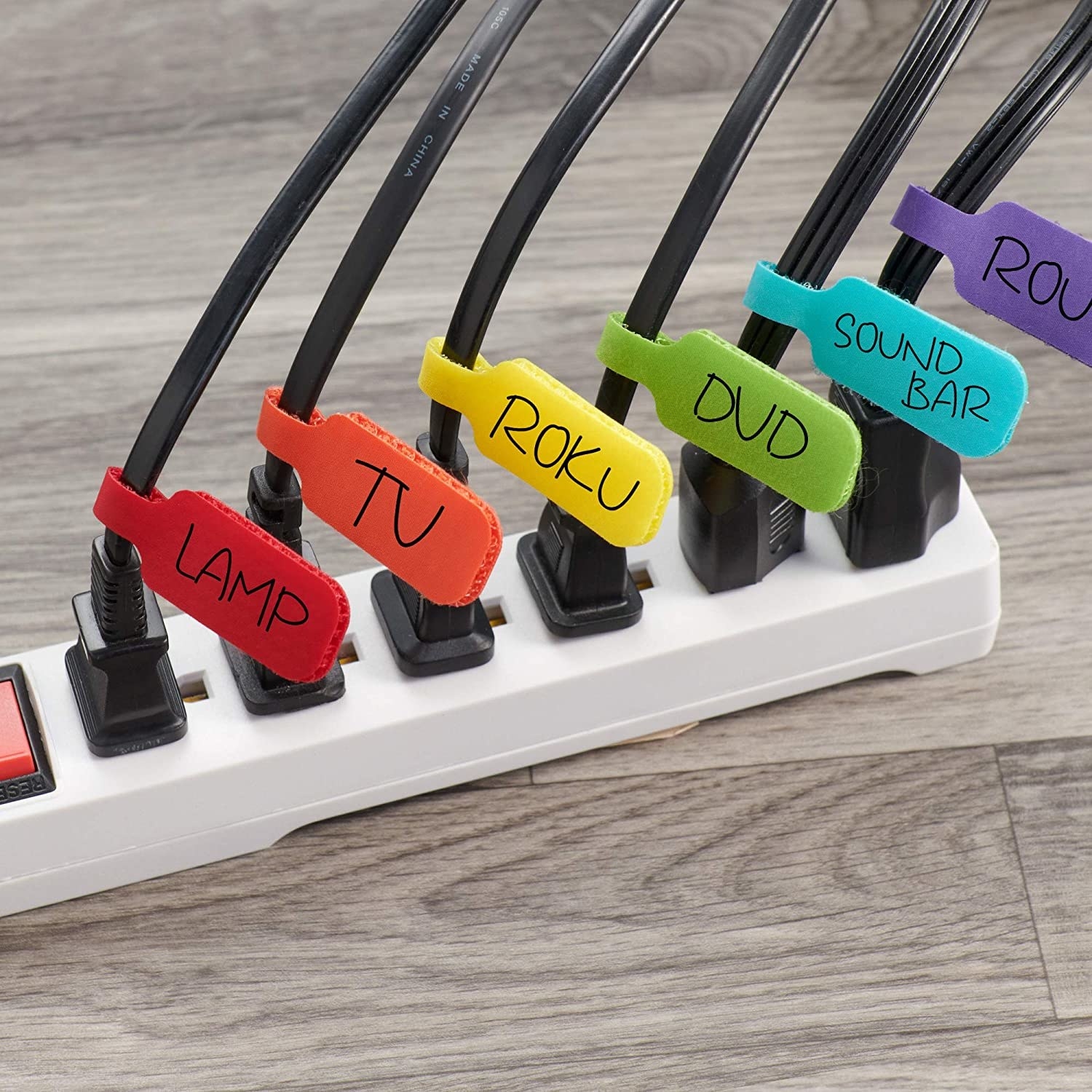 the colourful labels on a bunch of cables plugged into a power bar