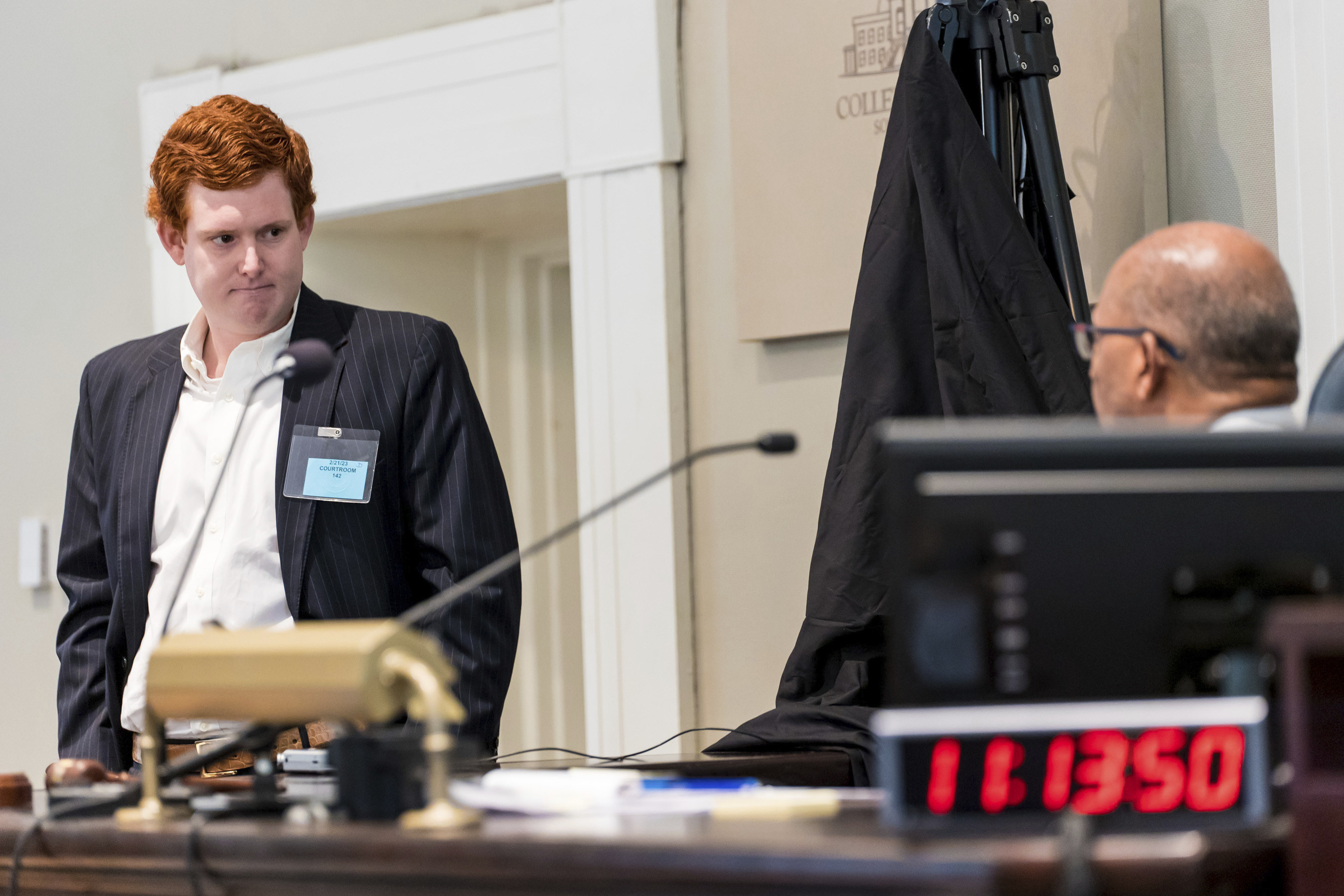 Buster Murdaugh, right, the son of Alex Murdaugh, listens to a