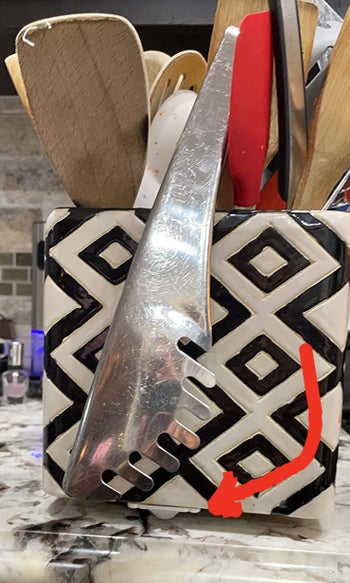 A reviewer's utensil holder with the wheels attached to the bottom