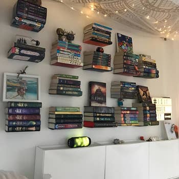 another reviewer photograph of their partition with respective floating bookshelves holding respective stacks of books