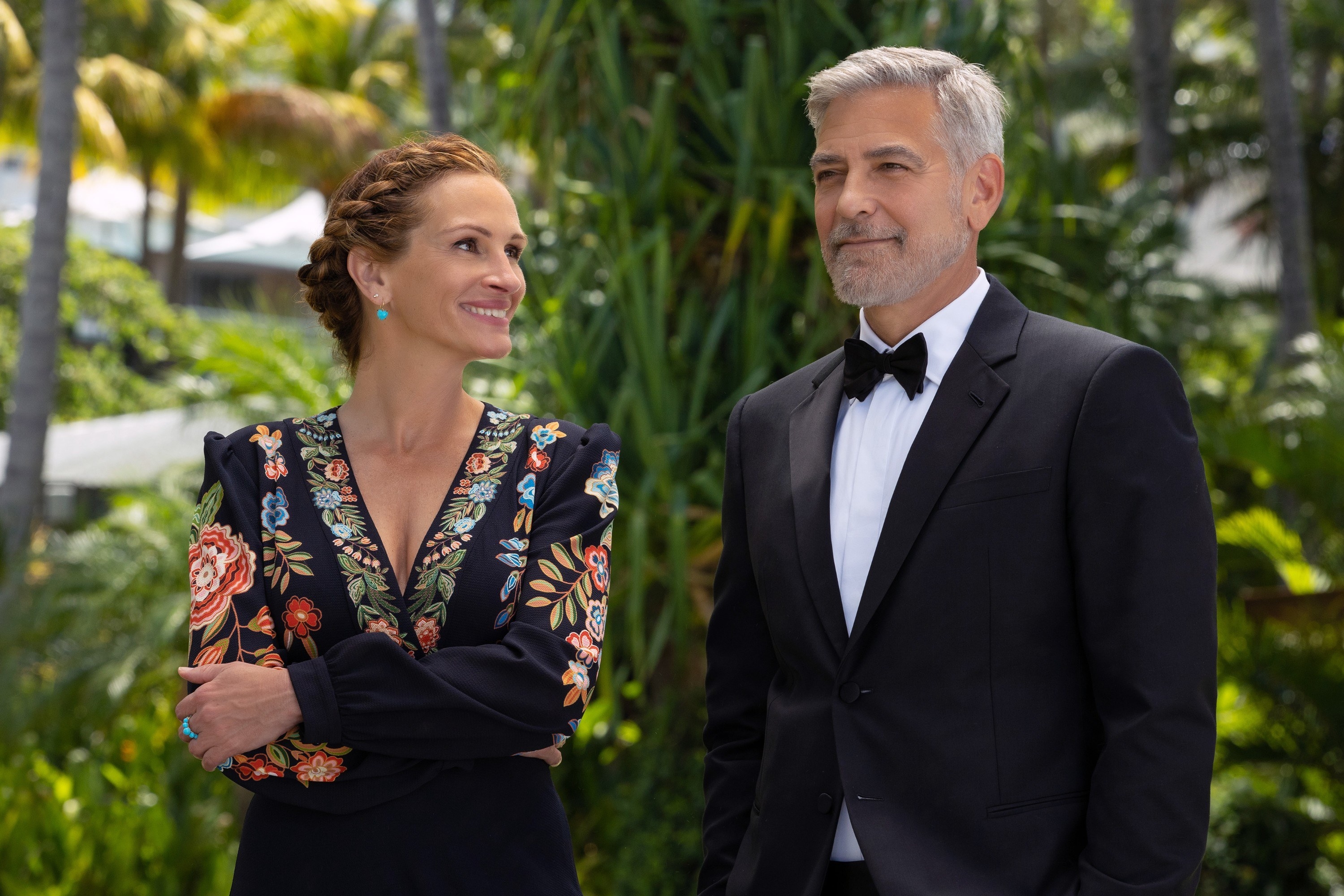 Julia Roberts and George Clooney stand at a tropical wedding
