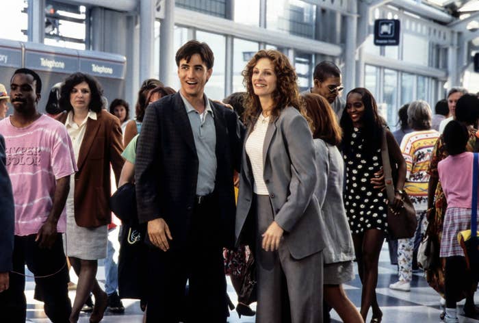 Dermot Mulroney and Julia Roberts stand in an airport
