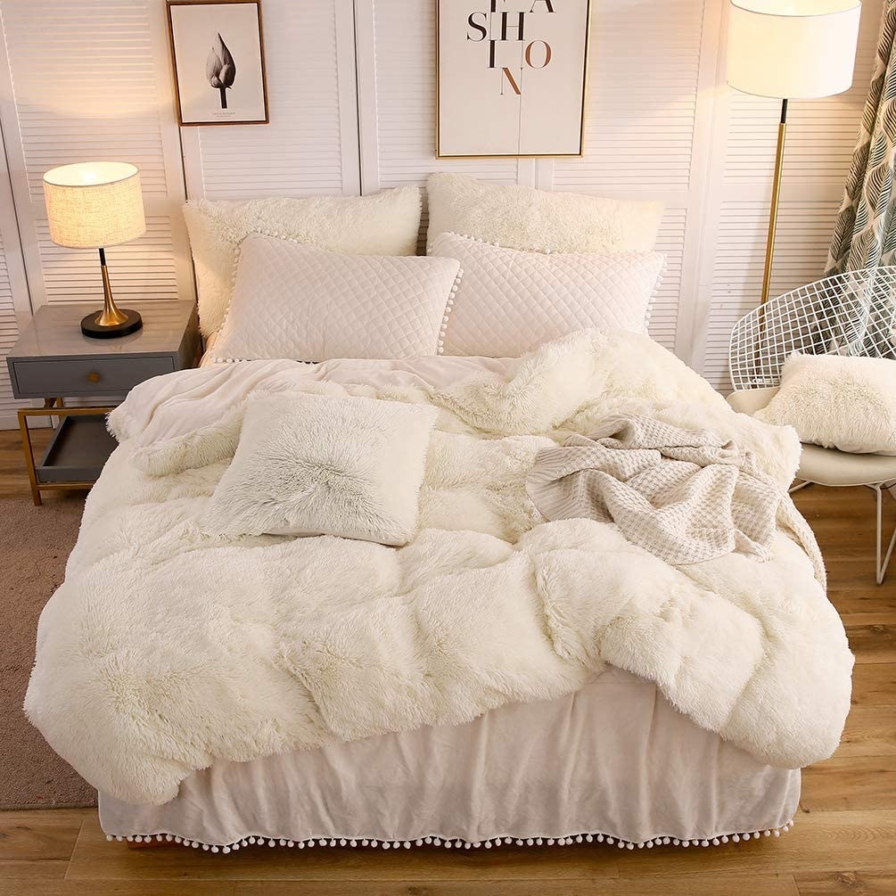 a white shaggy faux fur duvet cover on a bed