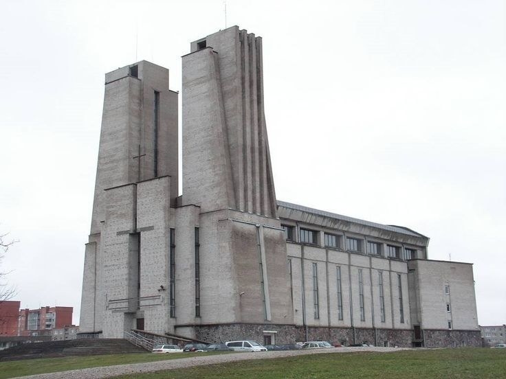 cement church building with two towers, and narrow slits for windows