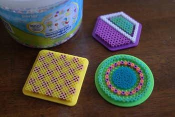 a reviewer photograph of the bucket of perler beads and the peg boards