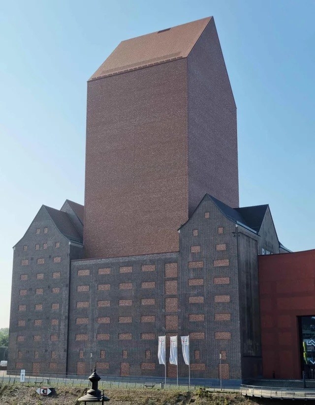 An extremely tall building made of all brick with no windows