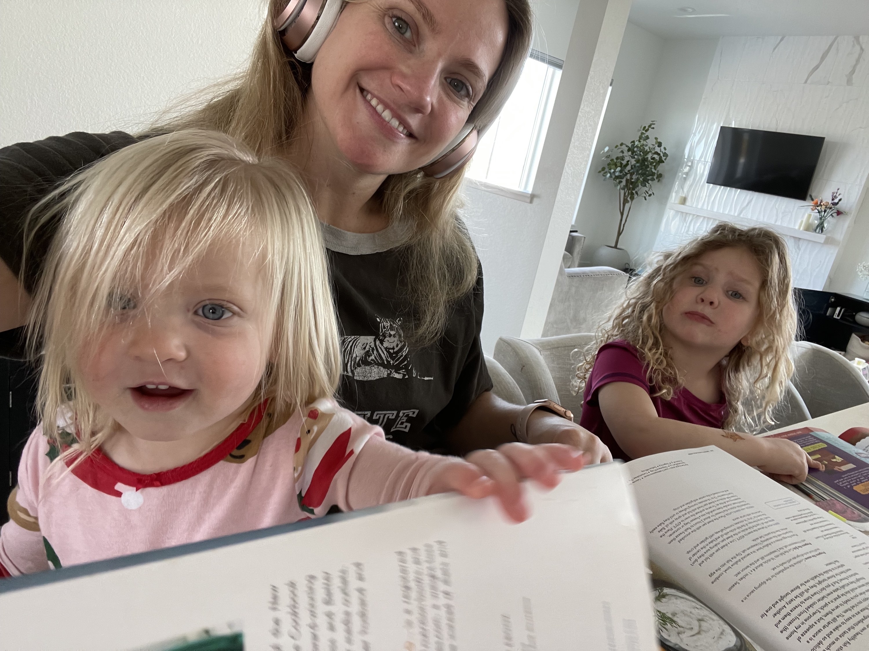 the author and her daughters looking at cookbooks