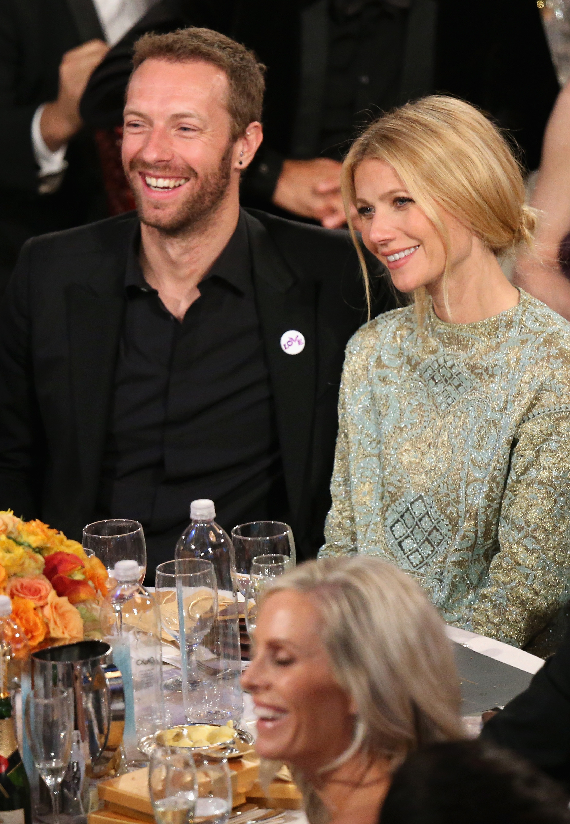 Chris Martin and Gwyneth Paltrow sitting together at an event