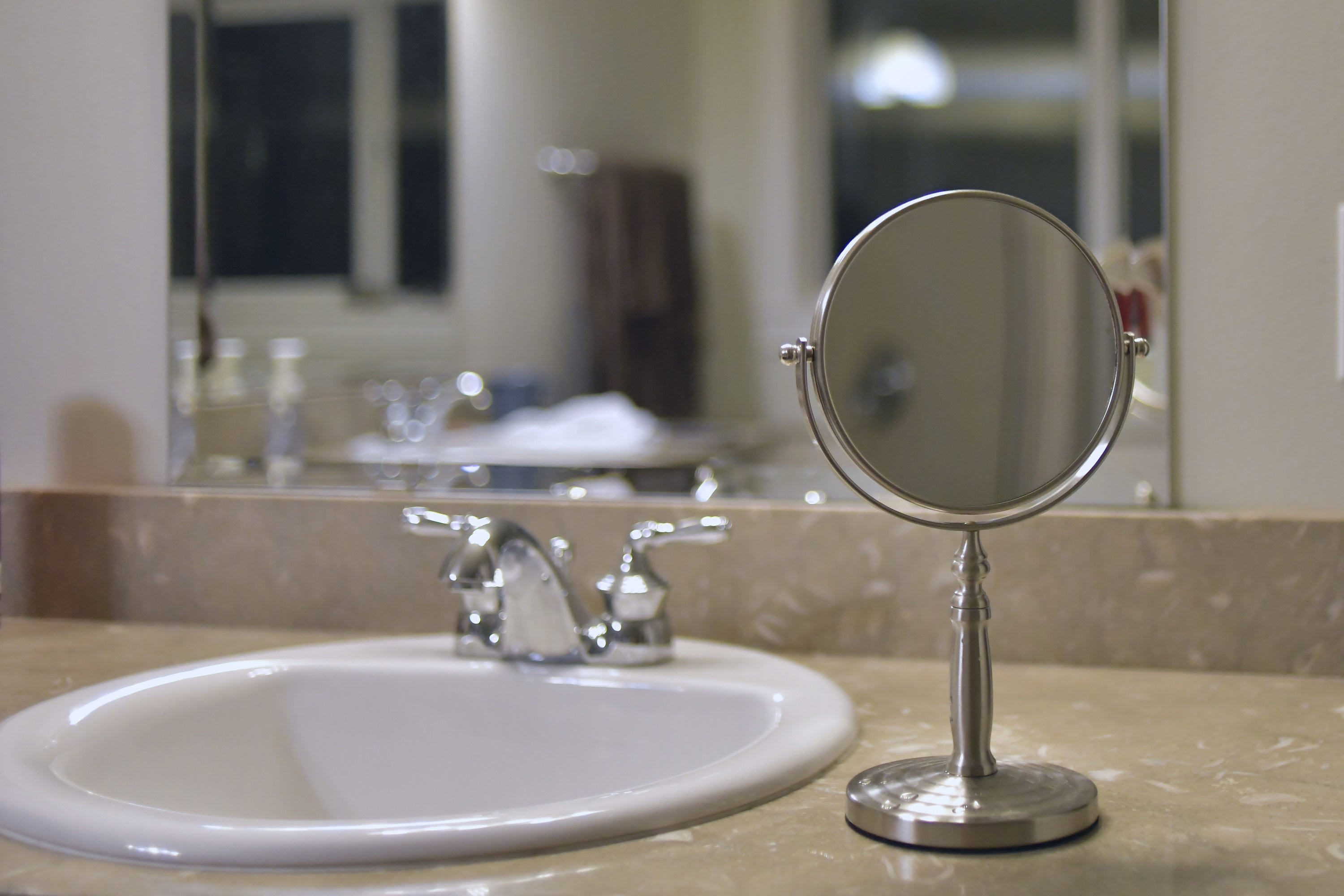 A bathroom sink with a mirror on it