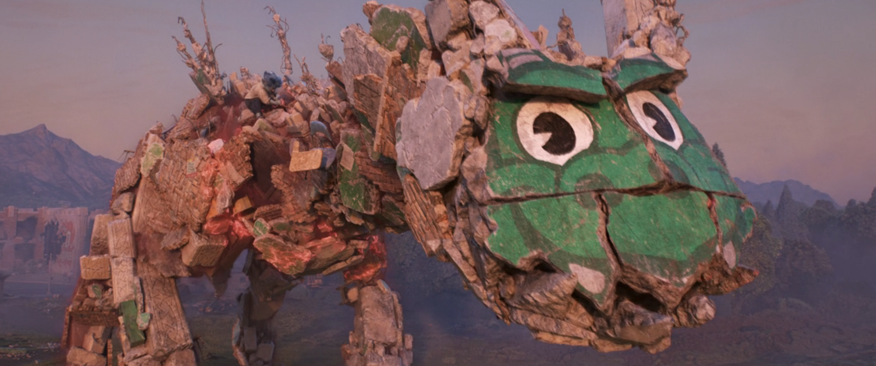 a large dragon made of debris with a stone high school mascot face