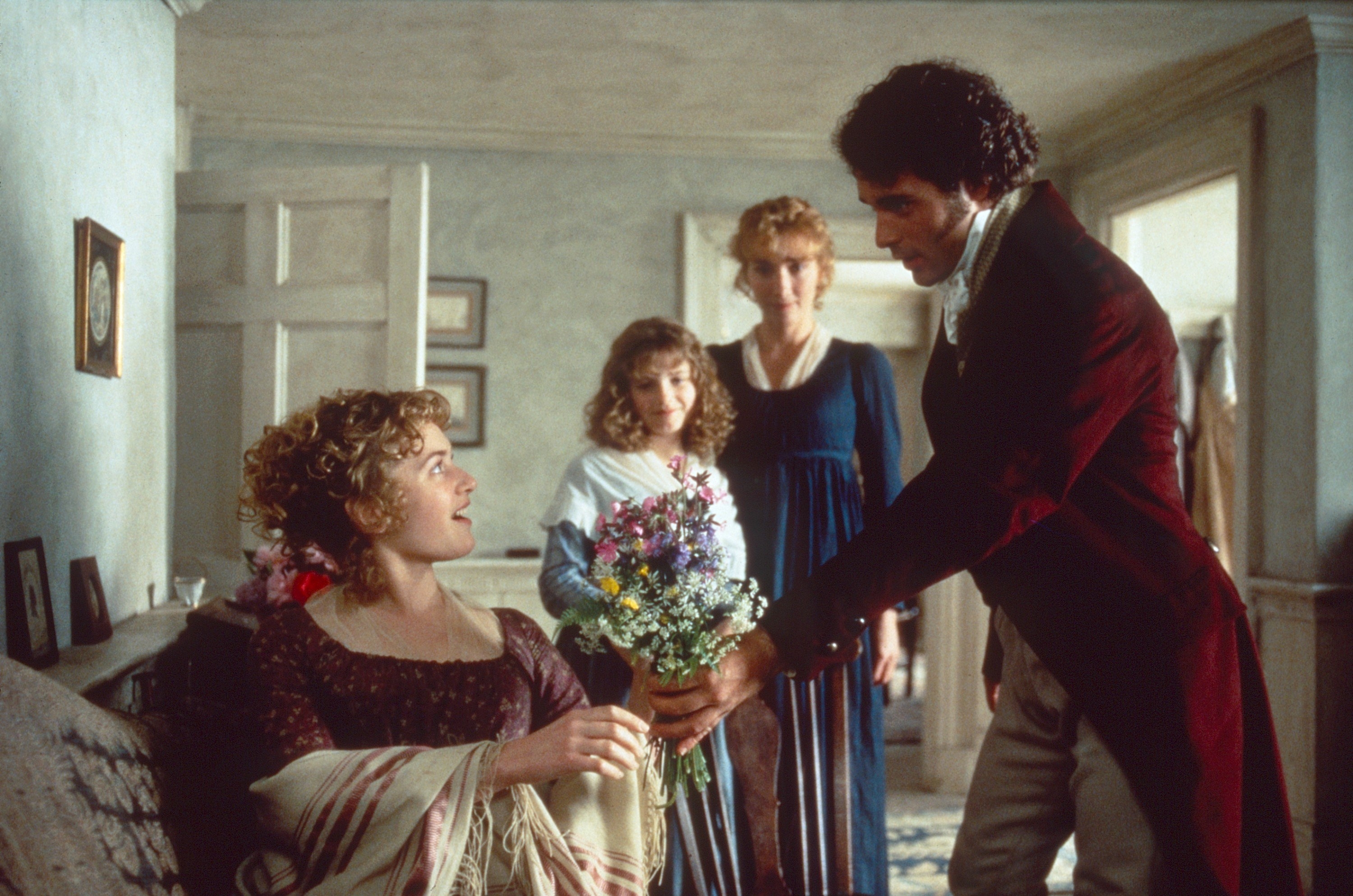 A man gives flowers to a young woman