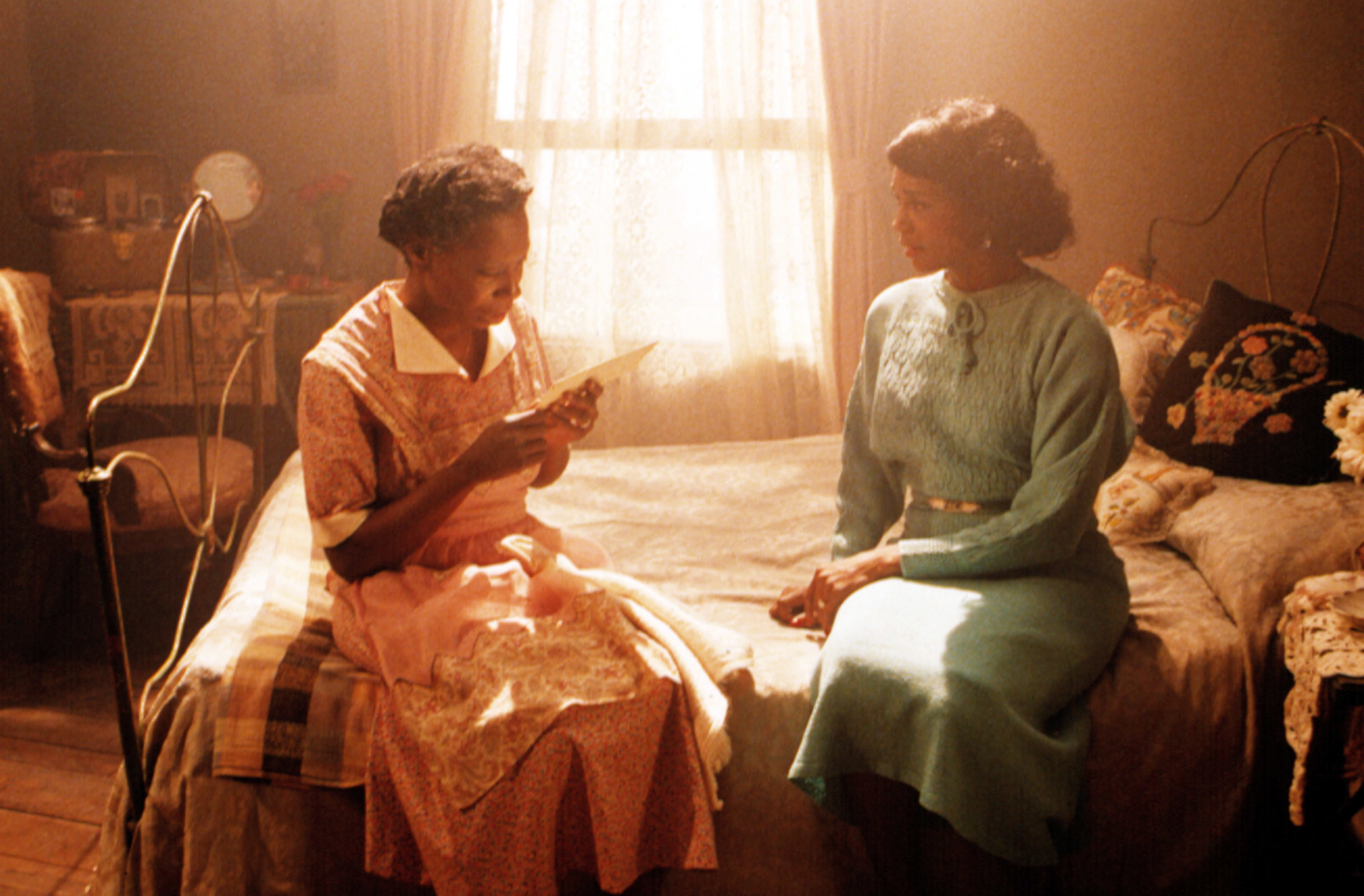 Celie and Shug sitting on a bed