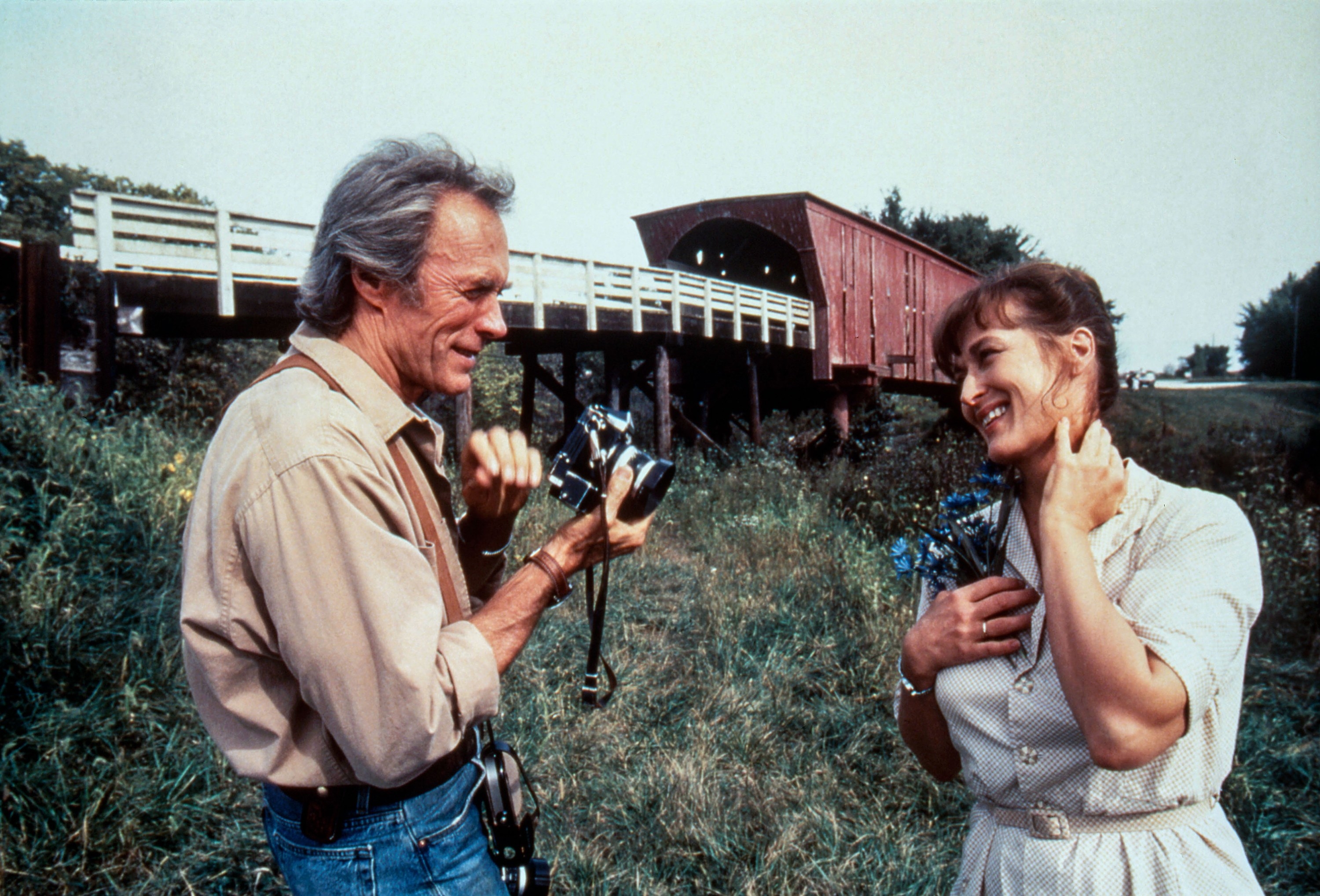 Clint holding a camera and smiling at Meryl