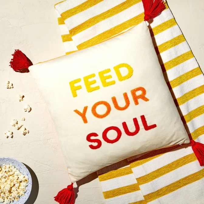 A pillow that says Feed Your Soul is shown