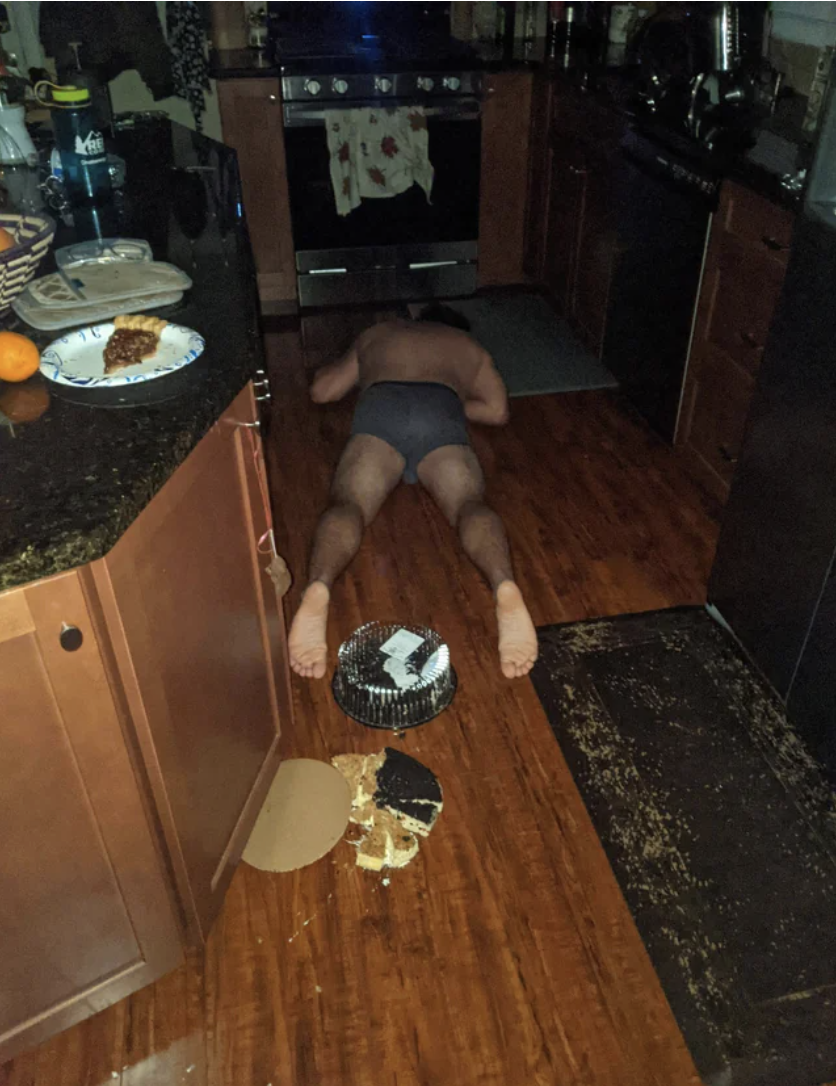 A man laying on the floor next to spilled pie
