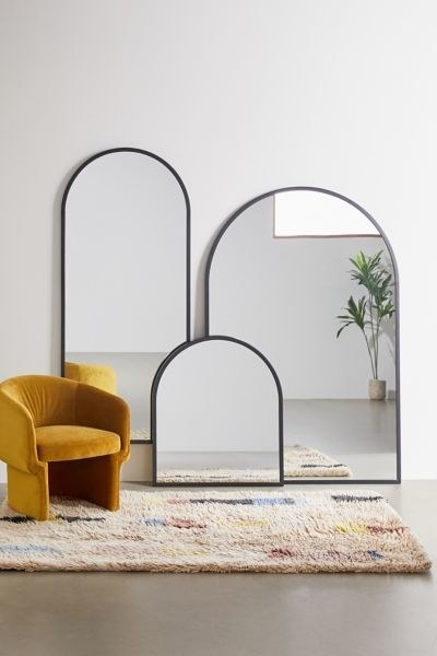 Three mirrors with arc shaped frames in different sizes