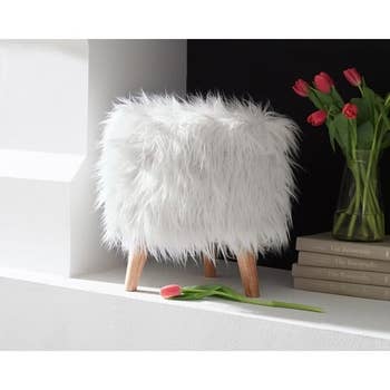 The super shaggy white faux fur storage ottoman with legs