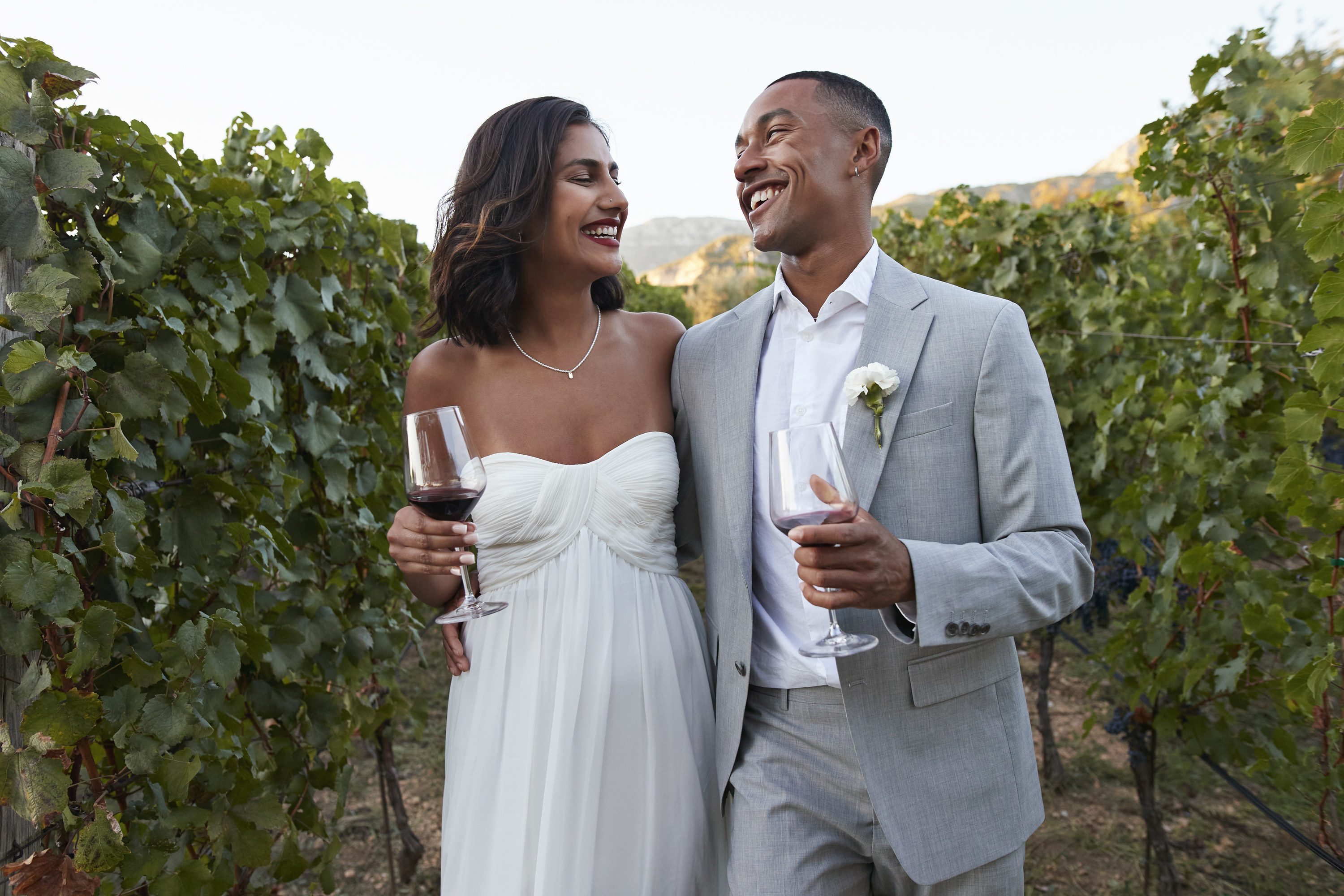 bride and groom looking at each other laughing