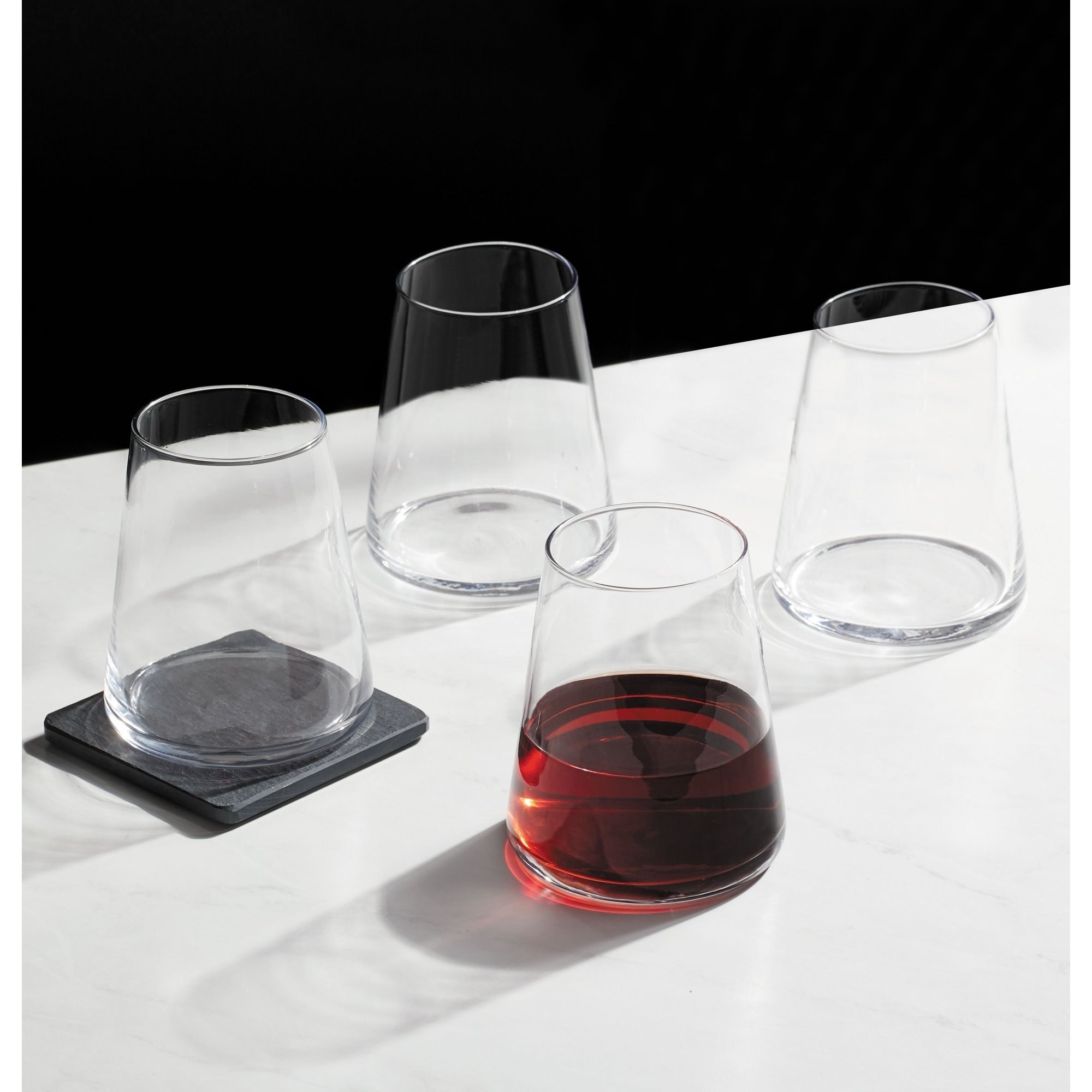The set of stemless wine glasses on a counter
