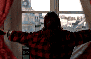 Emily from &quot;Emily in Paris&quot; opening her windows to a view.